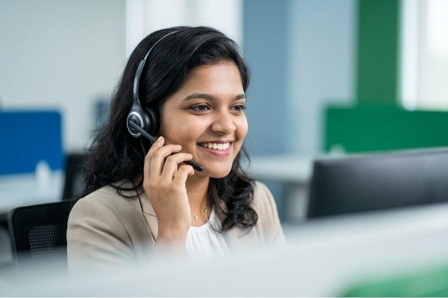 Telecaller wearing a headset taking a customer call
